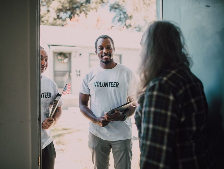 Volunteers talking with people at an outreach event