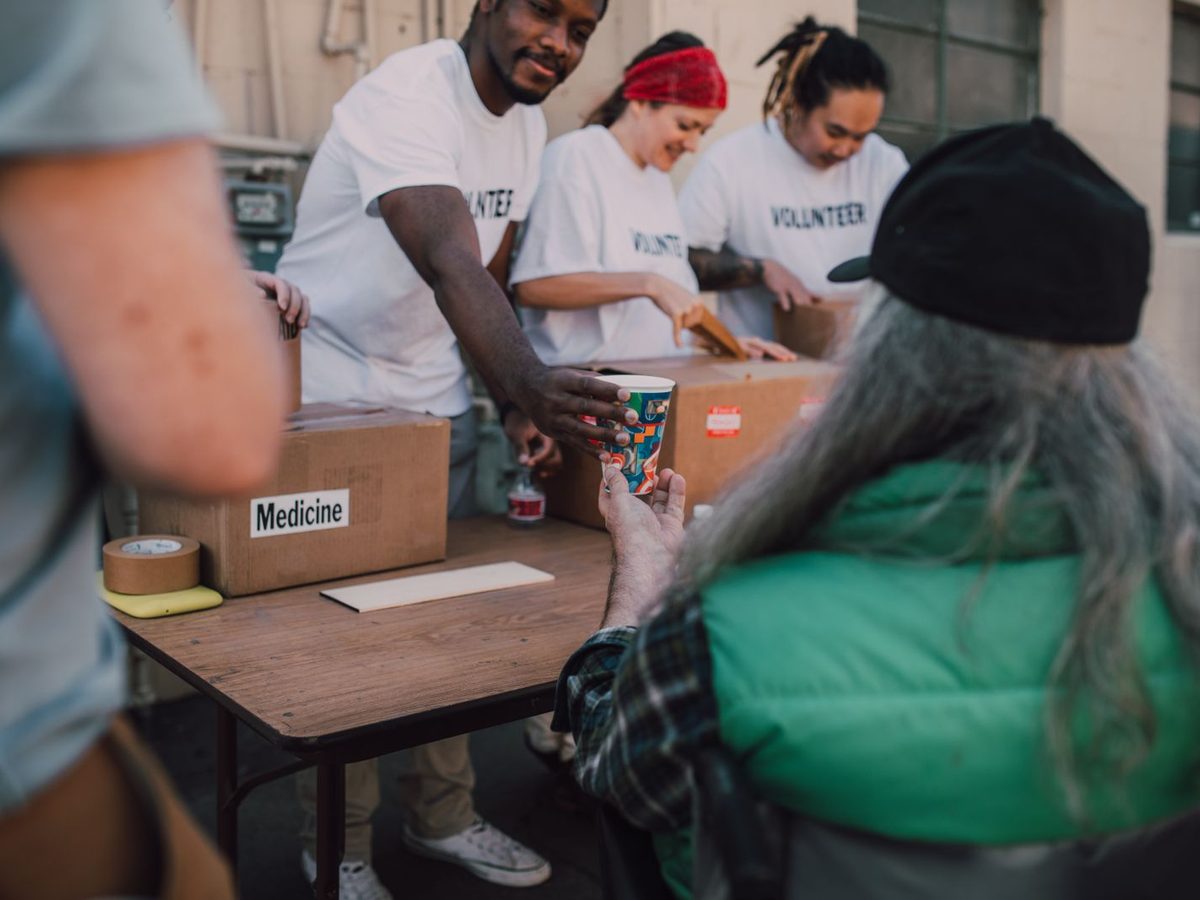 Volunteers packing food and supplies at a table