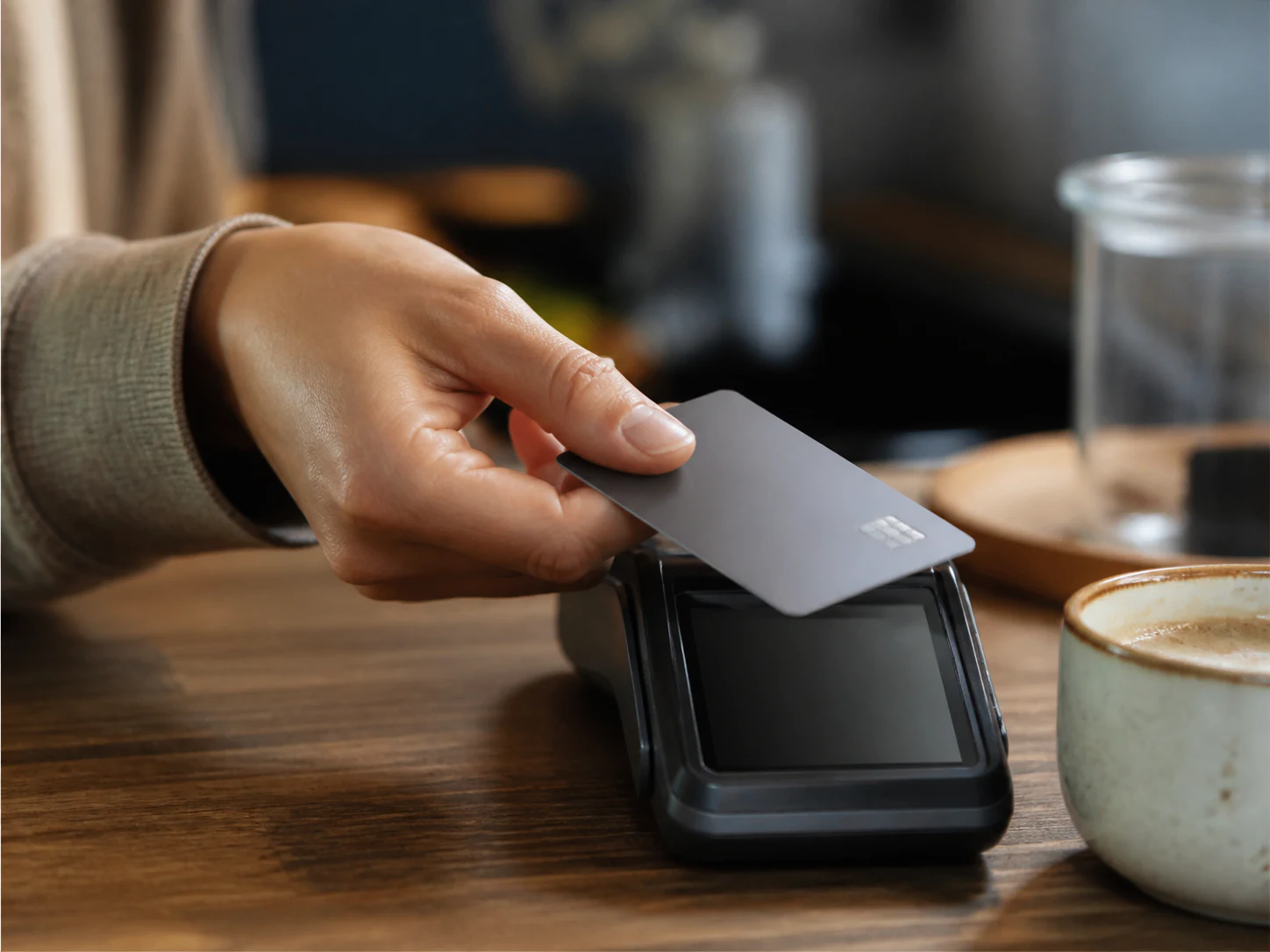 Customer tapping a handheld payment terminal