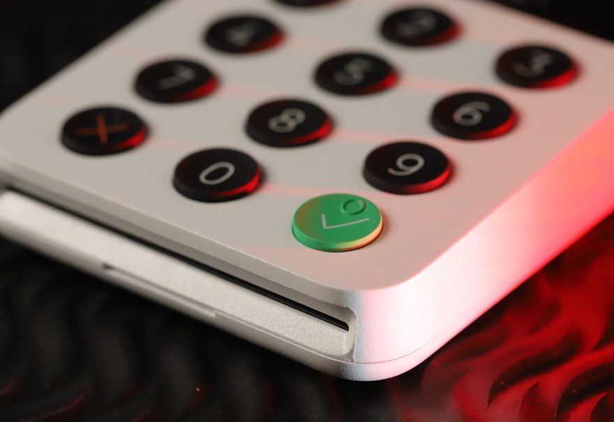 A close-up of a compact card reader keypad