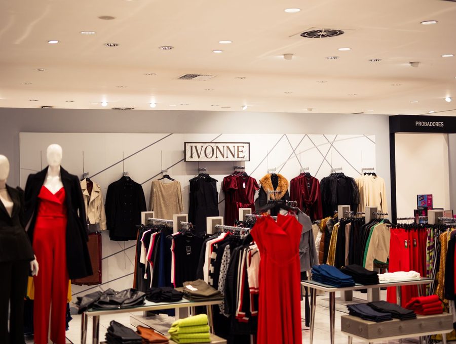 Rails of clothing on a bright shop floor
