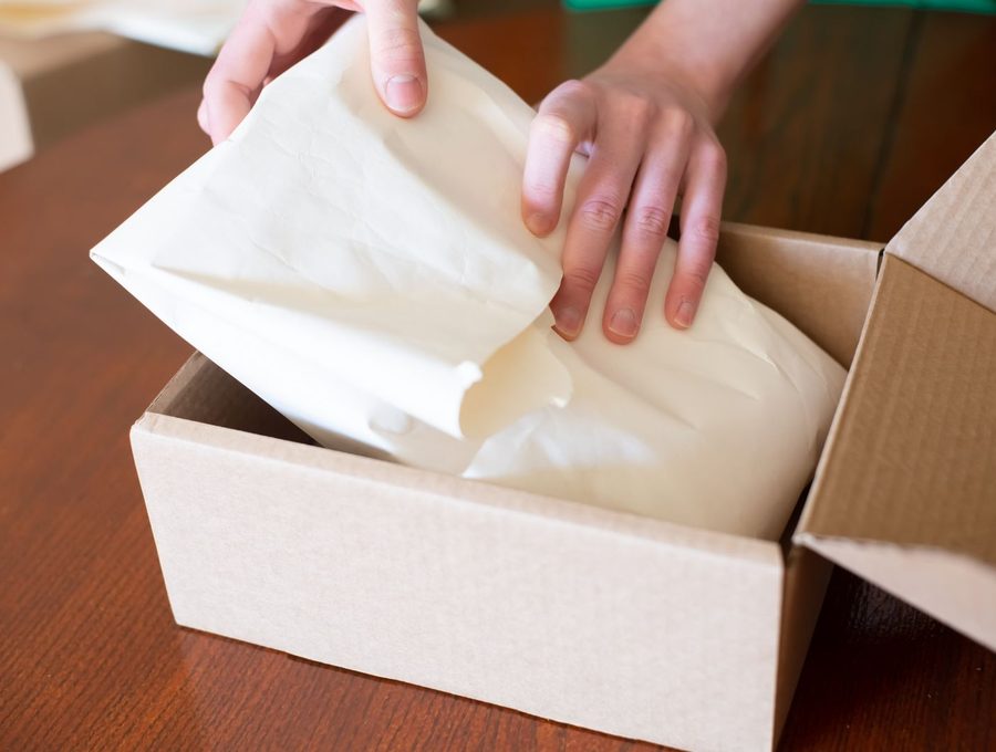 An order being packed into a box for shipping