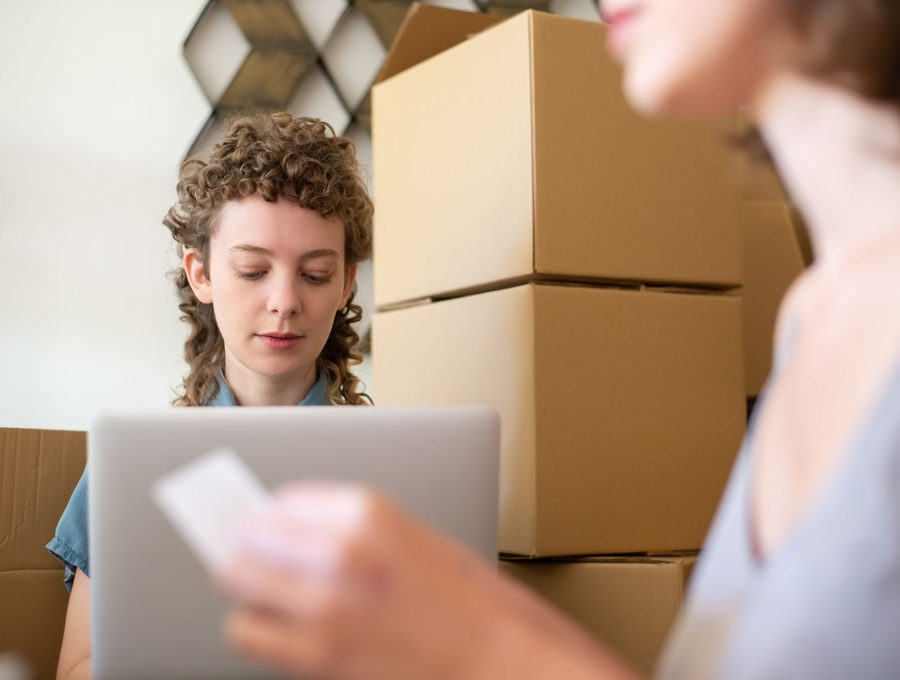 A small business owner working among stock boxes