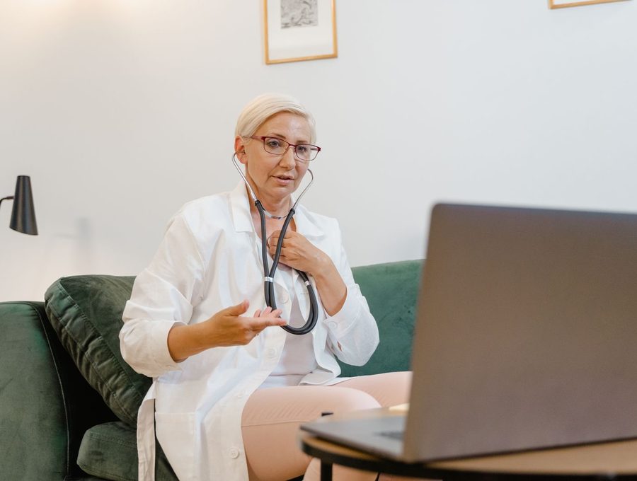 A clinician holding a remote consultation on a laptop