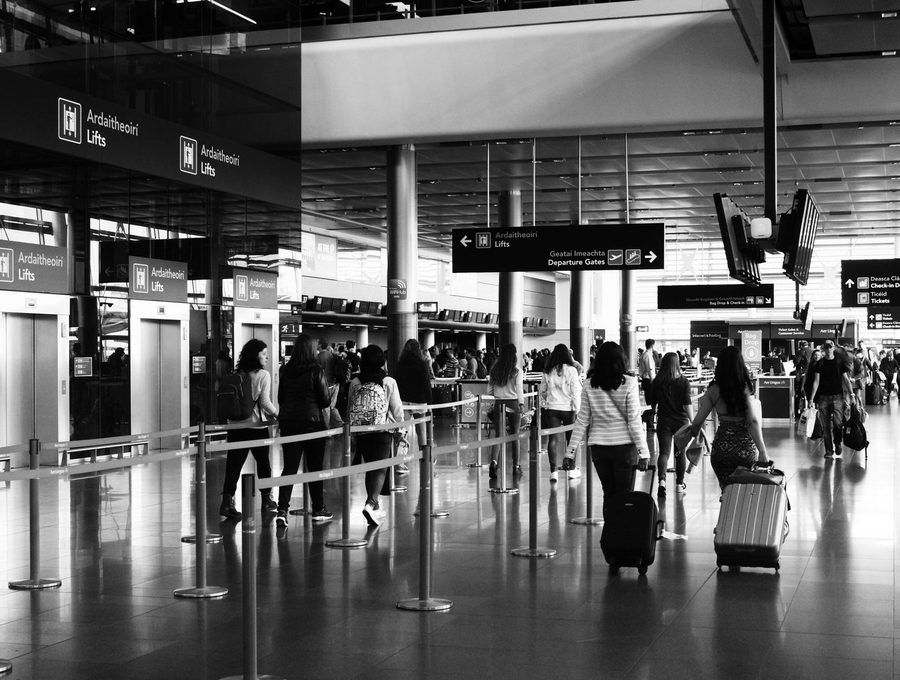 Travellers moving through an airport terminal